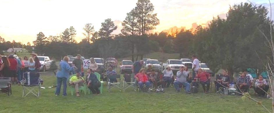 People on the lawn at dusk